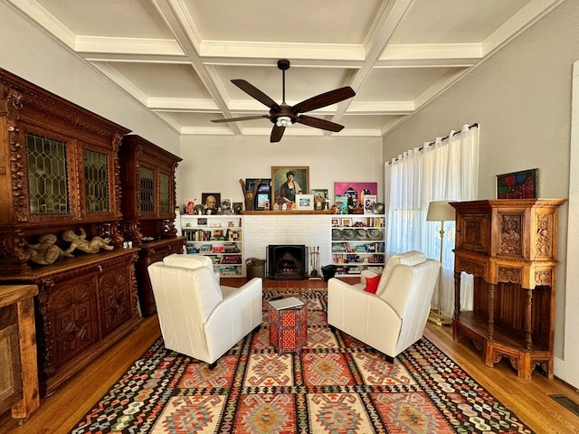 living room with wood-type flooring, coffered ceiling, and beam ceiling