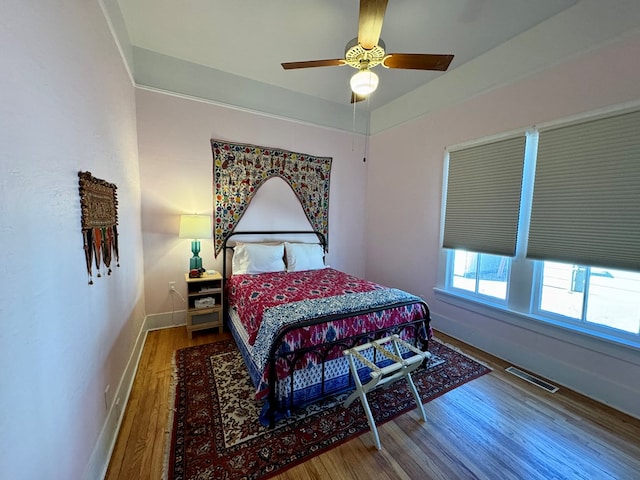 bedroom with ceiling fan and hardwood / wood-style flooring