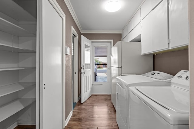 laundry area featuring dark wood-style flooring, baseboards, ornamental molding, and washer and clothes dryer