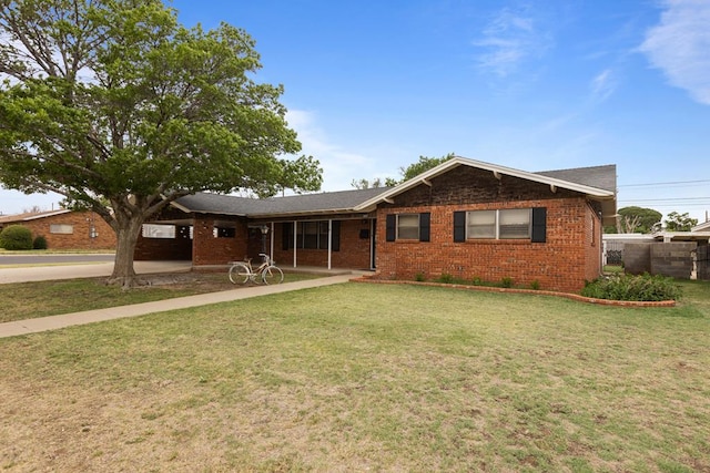 ranch-style home featuring brick siding and a front yard