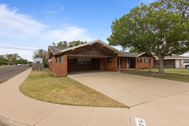 ranch-style house with an attached carport, driveway, a front lawn, and brick siding