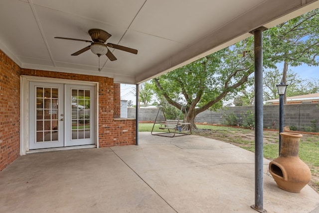 view of patio / terrace with a fenced backyard, ceiling fan, and french doors