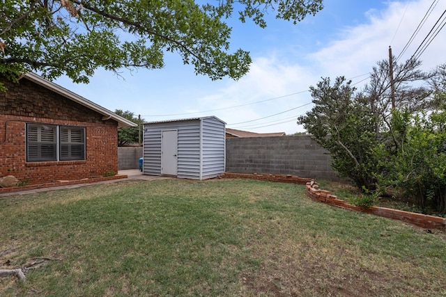 view of yard featuring an outdoor structure, fence, and a shed