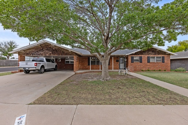 ranch-style house featuring a garage, concrete driveway, a front yard, and brick siding