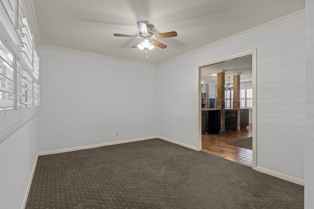 unfurnished room with dark colored carpet, a ceiling fan, baseboards, and ornamental molding