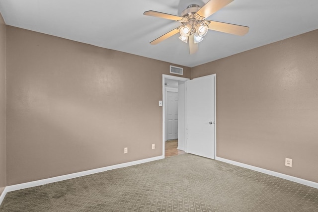 unfurnished room featuring baseboards, ceiling fan, carpet flooring, and visible vents