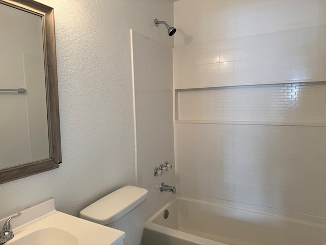 bathroom featuring shower / washtub combination, toilet, and vanity