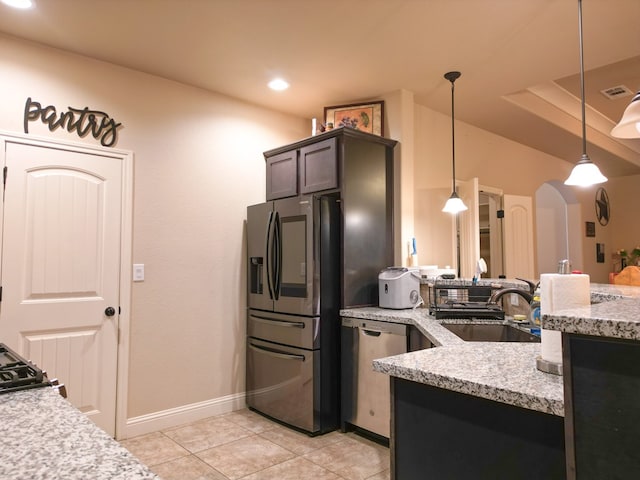 32 Balmoral Cir, Odessa, TX 79765 - kitchen featuring stainless steel appliances, pendant lighting, light tile patterned floors, light stone countertops, and arched walkways