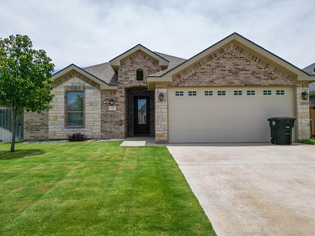 32 Balmoral Cir, Odessa, TX 79765 - french country inspired facade with an attached garage, concrete driveway, a front lawn, brick siding, and stone siding