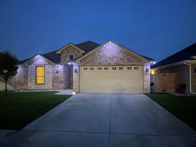 32 Balmoral Cir, Odessa, TX 79765 - view of front of house with concrete driveway, an attached garage, stone siding, and brick siding