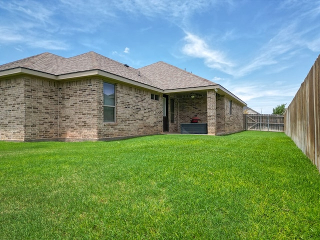 32 Balmoral Cir, Odessa, TX 79765 - back of house with brick siding, a fenced backyard, and roof with shingles