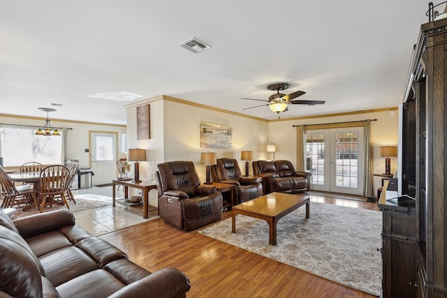 203 NE 8th St, Marathon, TX 79842 - living room featuring ornamental molding, healthy amount of natural light, a ceiling fan, french doors, and wood finished floors
