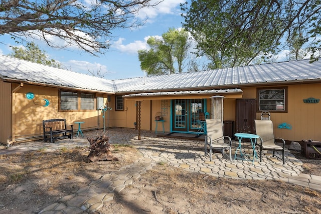 203 NE 8th St, Marathon, TX 79842 - rear view of house featuring metal roof and a patio