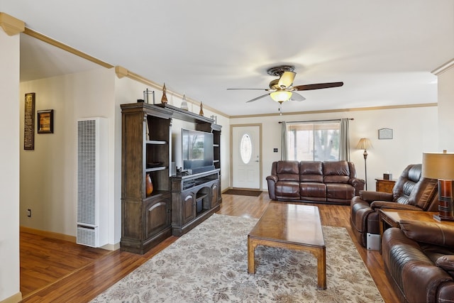 203 NE 8th St, Marathon, TX 79842 - living area featuring a heating unit, wood finished floors, ceiling fan, baseboards, and crown molding