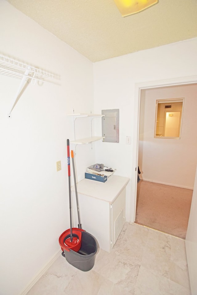 clothes washing area with electric panel