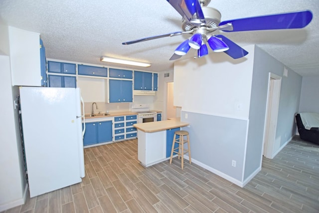 kitchen featuring sink, light hardwood / wood-style flooring, blue cabinets, kitchen peninsula, and white appliances