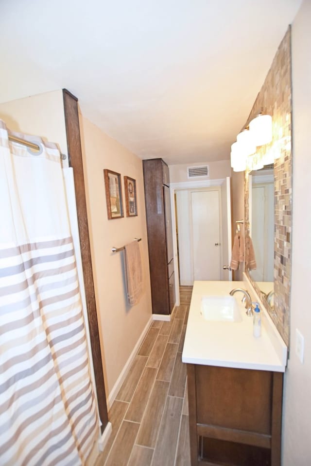 bathroom featuring hardwood / wood-style floors and vanity