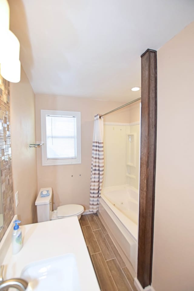 full bathroom featuring shower / bath combo, toilet, and sink