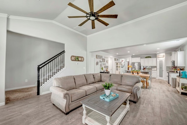 8430 E County Rd 114, Midland, TX 79706 - living room featuring light wood-style floors, a ceiling fan, stairs, vaulted ceiling, and ornamental molding