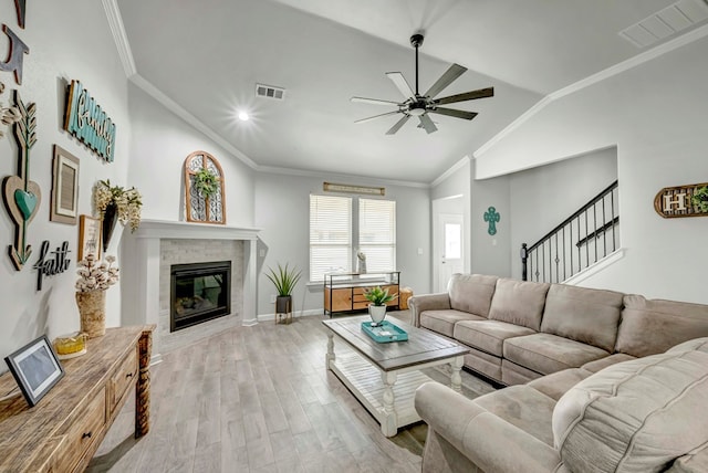 8430 E County Rd 114, Midland, TX 79706 - living area featuring a ceiling fan, light wood-style flooring, a glass covered fireplace, lofted ceiling, and baseboards