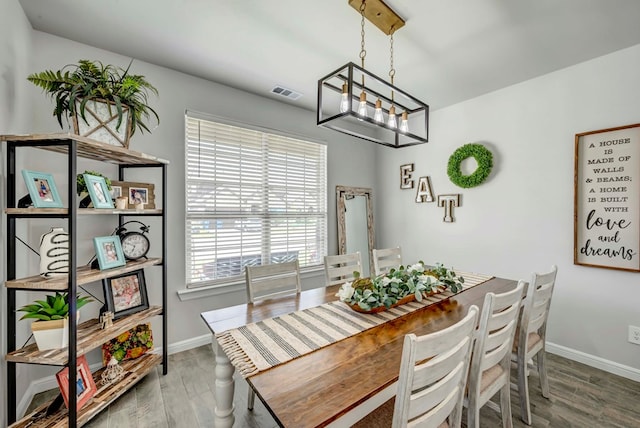 8430 E County Rd 114, Midland, TX 79706 - dining space featuring wood finished floors, baseboards, and a chandelier
