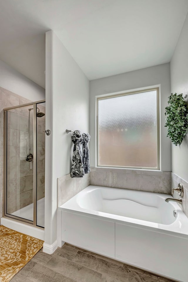 8430 E County Rd 114, Midland, TX 79706 - full bathroom with a garden tub, a stall shower, and wood finished floors