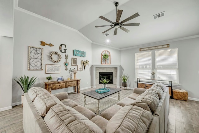 8430 E County Rd 114, Midland, TX 79706 - living area with a ceiling fan, ornamental molding, vaulted ceiling, baseboards, and light wood-style floors