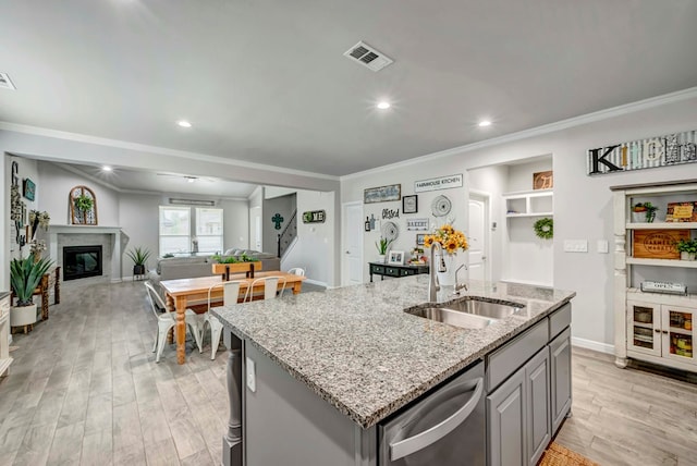 8430 E County Rd 114, Midland, TX 79706 - kitchen featuring a sink, dishwasher, gray cabinetry, crown molding, and an island with sink