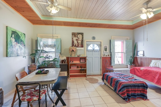 106 SE 4th St, Marathon, TX 79842 - living room featuring ceiling fan, wood ceiling, a raised ceiling, light tile patterned flooring, and crown molding