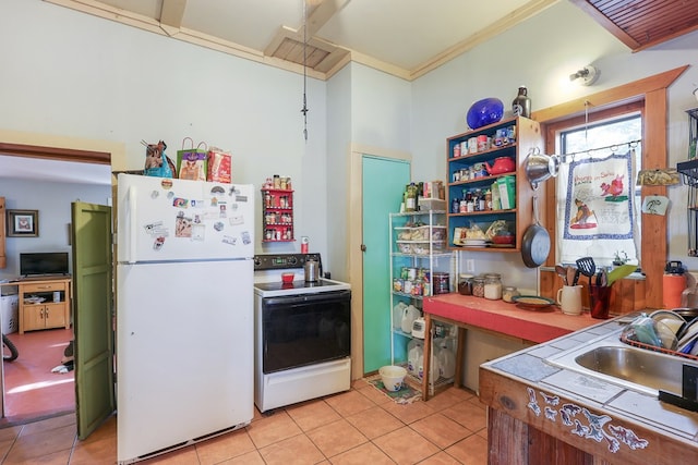 106 SE 4th St, Marathon, TX 79842 - kitchen featuring freestanding refrigerator, electric stove, light tile patterned floors, tile counters, and ornamental molding