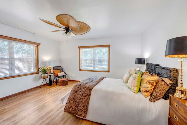 1600 W Kansas Ave, Midland, TX 79701 - bedroom with multiple windows, light wood-style flooring, and a ceiling fan