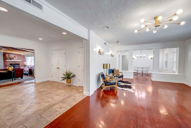 1600 W Kansas Ave, Midland, TX 79701 - living room featuring a chandelier, a fireplace, and recessed lighting