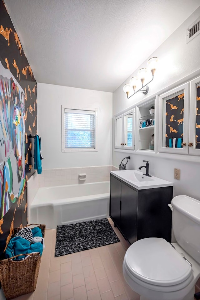 1600 W Kansas Ave, Midland, TX 79701 - full bathroom featuring a garden tub, vanity, and a textured ceiling