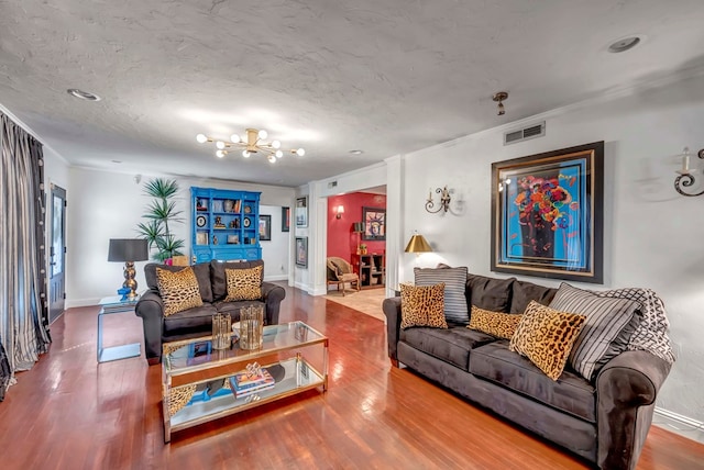 1600 W Kansas Ave, Midland, TX 79701 - living room featuring a chandelier, wood finished floors, and crown molding