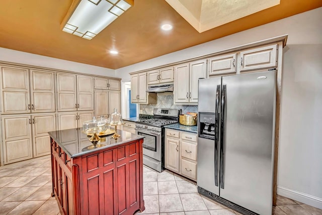 1600 W Kansas Ave, Midland, TX 79701 - kitchen featuring stainless steel appliances, under cabinet range hood, dark countertops, light tile patterned flooring, and recessed lighting
