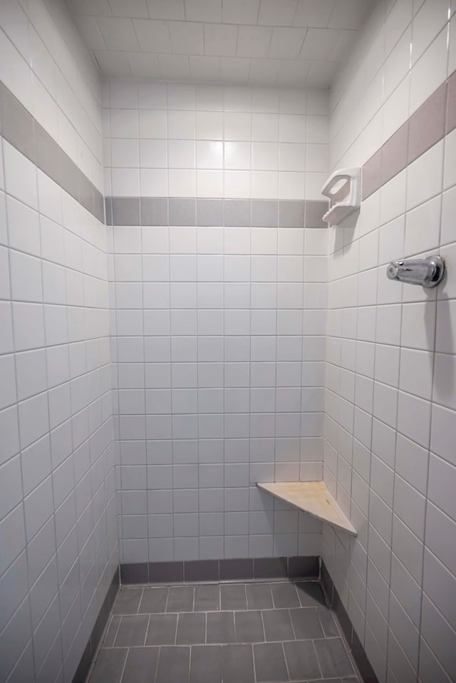 1600 W Kansas Ave, Midland, TX 79701 - bathroom with tile patterned flooring, tiled shower, and tile walls