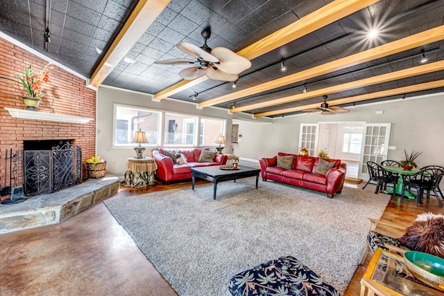 1600 W Kansas Ave, Midland, TX 79701 - living room featuring ceiling fan, concrete floors, beamed ceiling, a brick fireplace, and rail lighting