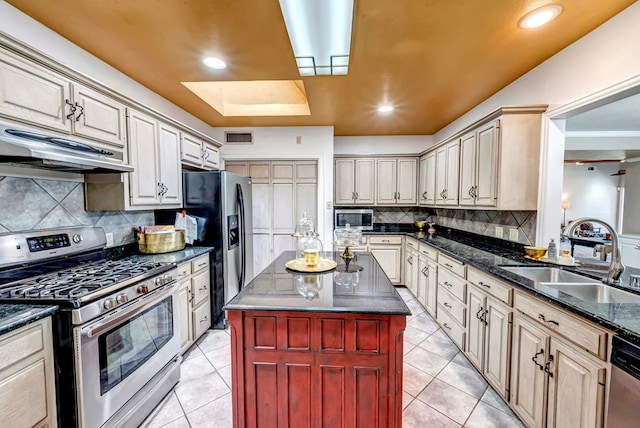 1600 W Kansas Ave, Midland, TX 79701 - kitchen with stainless steel appliances, under cabinet range hood, light tile patterned flooring, tasteful backsplash, and recessed lighting