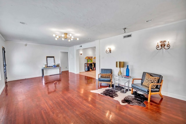 1600 W Kansas Ave, Midland, TX 79701 - sitting room with wood finished floors, a chandelier, and crown molding