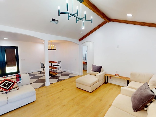 1411 NE Mustang Dr, Andrews, TX 79714 - living room with a chandelier, arched walkways, wood finished floors, and baseboards