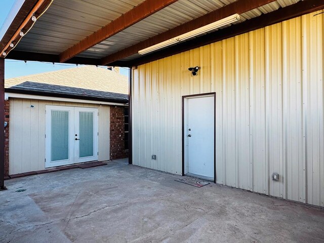 8801 N Rice Ave, Odessa, TX 79765 - doorway to property featuring a patio area, french doors, and roof with shingles