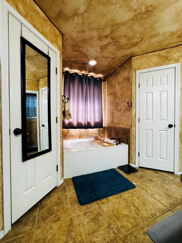 8801 N Rice Ave, Odessa, TX 79765 - bathroom featuring a bath and tile patterned flooring