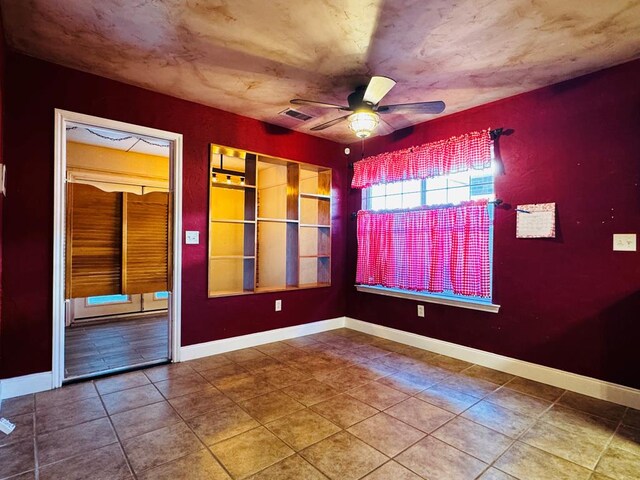 8801 N Rice Ave, Odessa, TX 79765 - tiled empty room featuring ceiling fan and baseboards