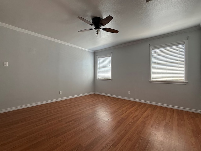 615 Placer Ave, Odessa, TX 79763 - empty room with wood finished floors, a ceiling fan, crown molding, baseboards, and a textured ceiling
