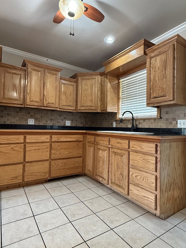 615 Placer Ave, Odessa, TX 79763 - kitchen featuring ornamental molding, a sink, ceiling fan, tasteful backsplash, and light tile patterned flooring