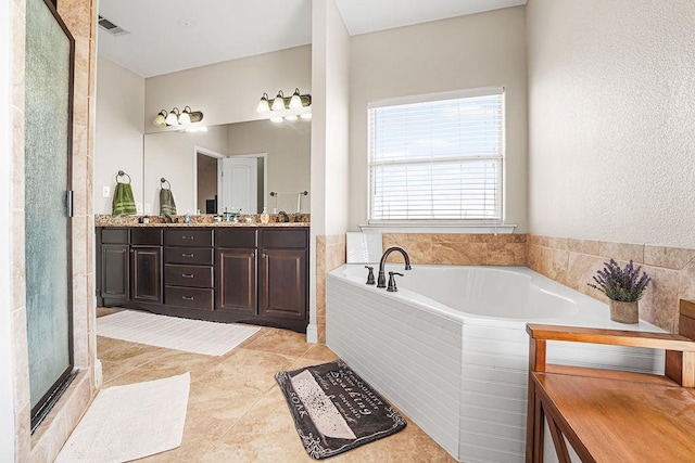 bathroom with a garden tub, double vanity, a shower with door, visible vents, and tile patterned floors