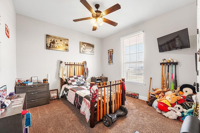 carpeted bedroom with a ceiling fan and baseboards