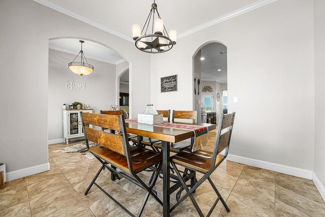dining area with arched walkways, baseboards, a notable chandelier, and ornamental molding