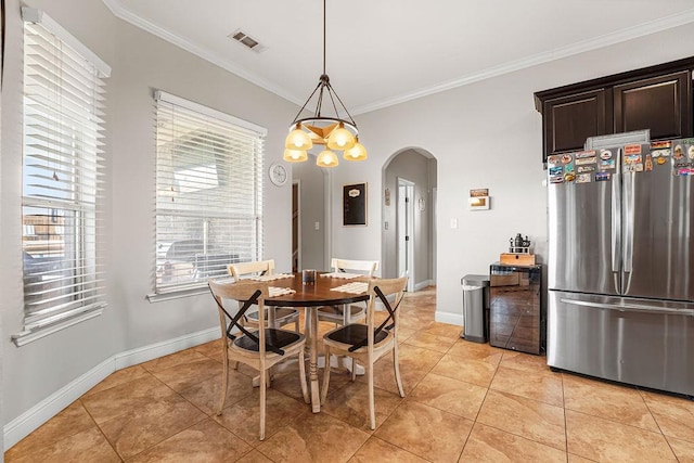 dining space featuring light tile patterned flooring, arched walkways, baseboards, visible vents, and ornamental molding