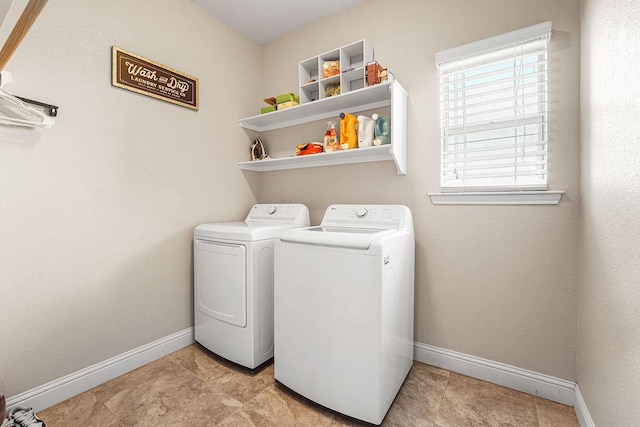 laundry room with washing machine and clothes dryer, laundry area, and baseboards